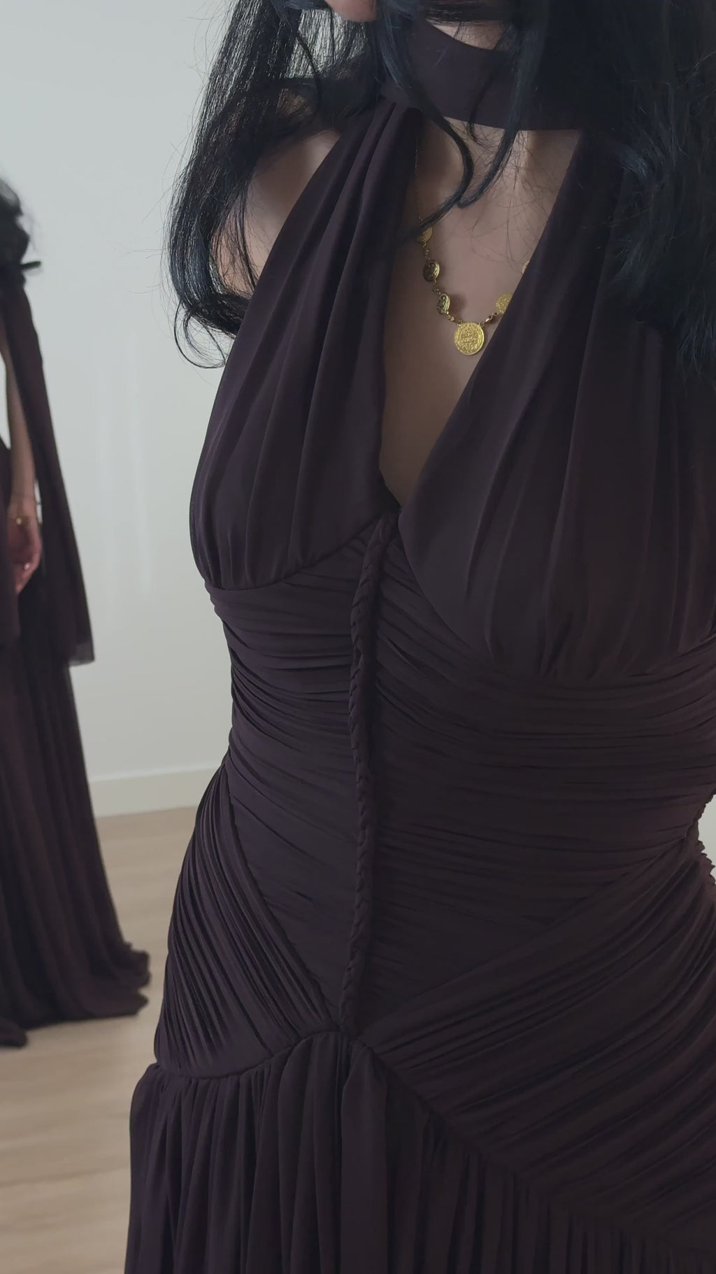 Video showcasing an elegant brown evening dress as the fabric moves.